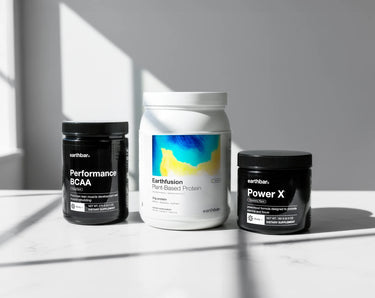 Three supplement containers on a light surface with a neutral background