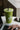 a green earthbar smoothie on a table next to a laptop