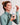 a woman in a turtleneck holding a dropper of amber liquid and the earthbar "it's time to detox" supplement bottle