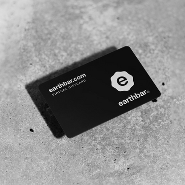 Black gift card with 'earthbar' branding on a gray surface