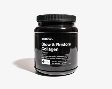 A black jar of earthbar Glow & Restore Collagen supplement on a white background.
