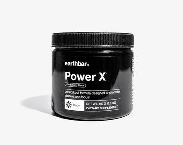 A jar of earthbar Power X pre-workout formula, which is a nutritional supplement designed to promote focus, energy, and power. The jar is black with white and silver text, and it is sealed with a black lid.