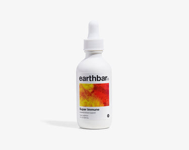 A bottle of 'Super Immune' herbal tonic by Earthbar with a dropper cap.