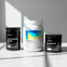 Three supplement containers on a light surface with a neutral background