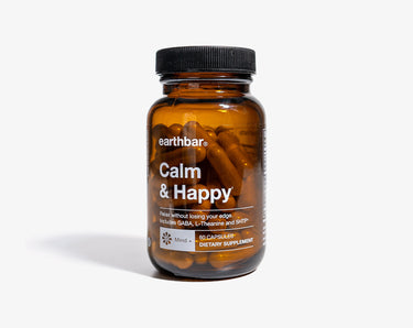 A bottle of 'Calm & Happy' supplement by Earthbar, with a label that includes the product name and branding.