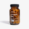 A bottle of Earthbar Focused Day supplements with a label showing the product name and branding.