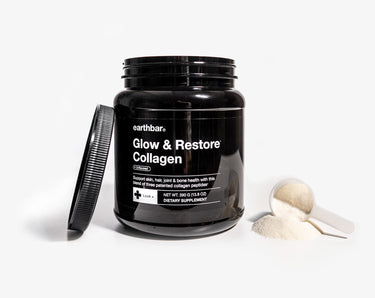 A jar of Earthbar's Glow & Restore Collagen with a scoop of powder next to it.