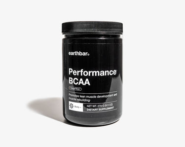 A black jar of earthbar Performance BCAA powder in orange flavor.